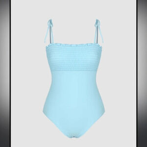 New with tags size small blue smocked one piece with sticker still attached